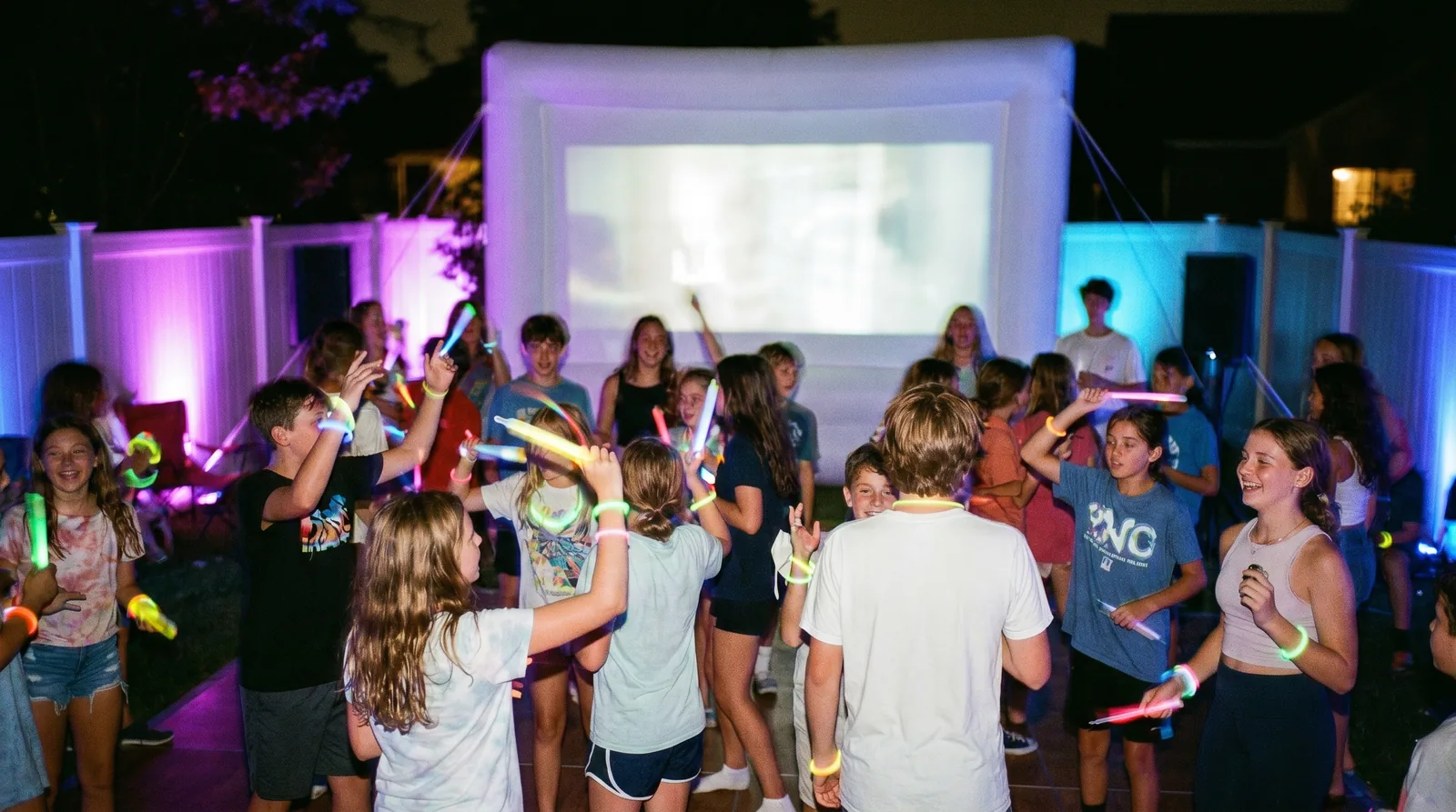 Kids glow dance party under neon lights at a High Desert backyard